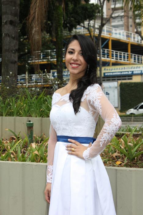 a girl in a white dress on the background of a house