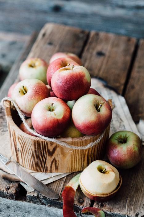 apples in a basket on a wooden table