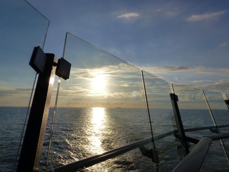 glass fence on the background of the sun