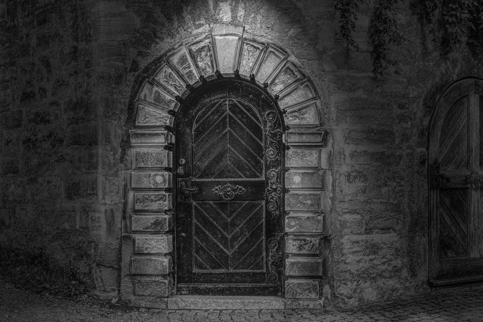 The door is a wooden stone arch