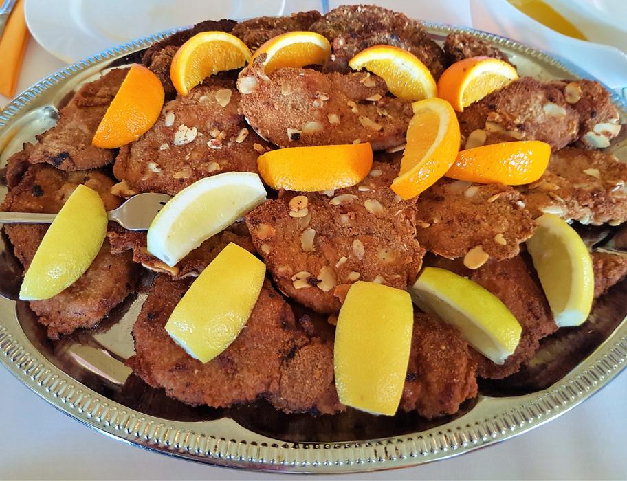 sliced meat with citrus fruits