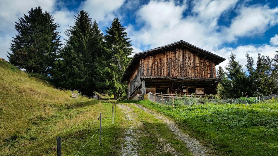 wooden house with clouds and grass