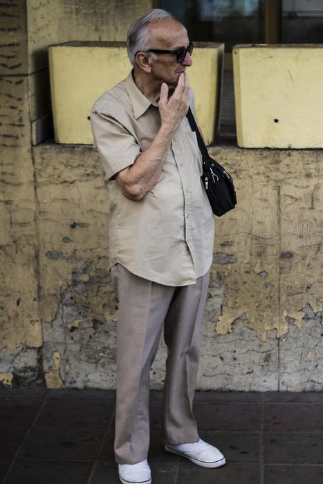 An old man at the bus stop