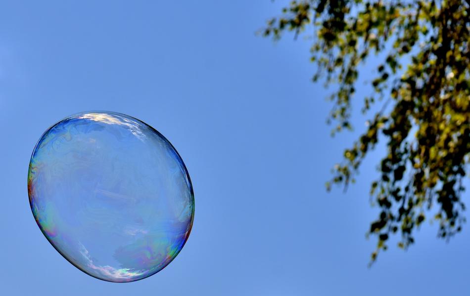 A bubble in the blue sky with trees