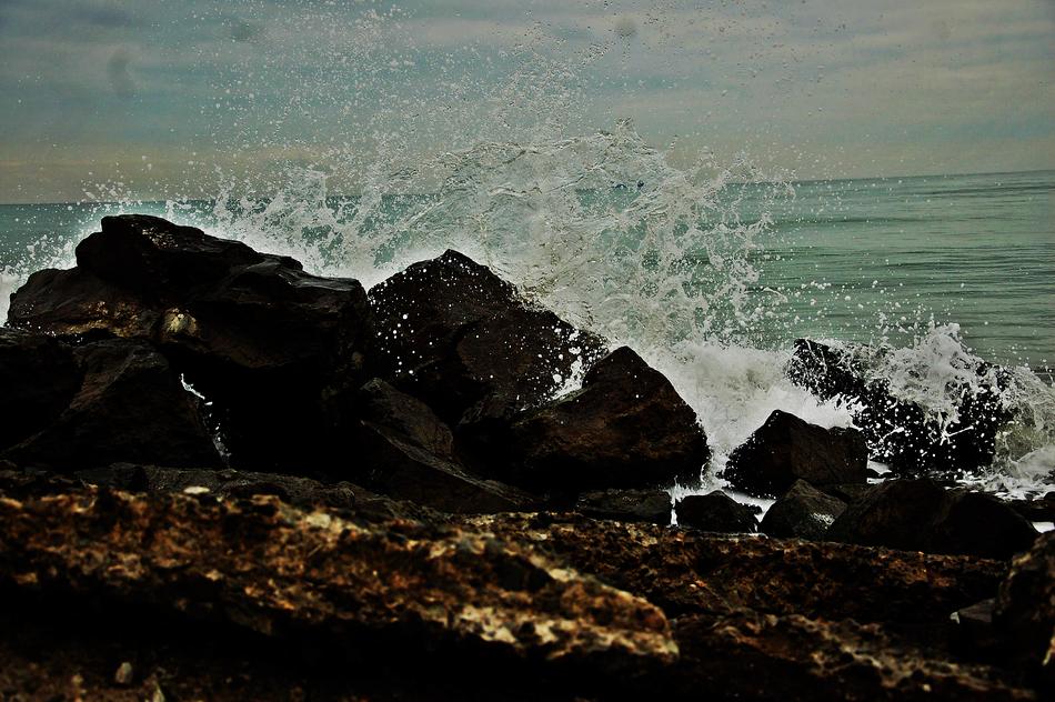 wave crashing on Beach Rocks