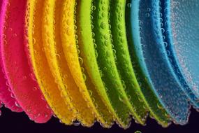 colorful plastic plates with drops of water