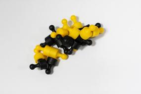 black and yellow magnets on white table