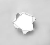 Turn hole in the white paper, on the white surface