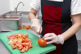 chef slices tomato