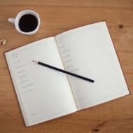 open notebook and a cup of coffee