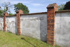 white plaster on an old brick fence