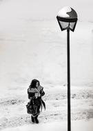 girl near a street lamp in winter