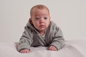caucasian Baby boy laying on stomach