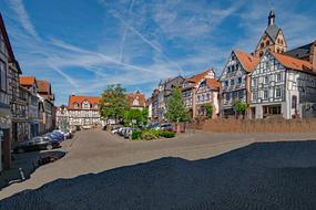 Beautiful and colorful Unterer Marktplatz, with the cars and green trees in Gelnhausen, Hesse, Germany