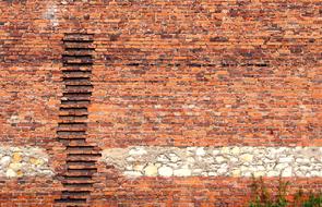 old brick wall of a building on the shore of Lake Dusia