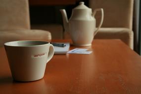 cute mug with a teapot on the table