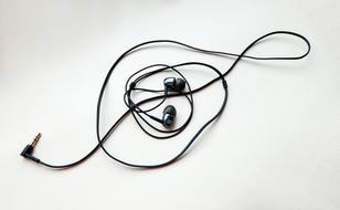 black wired headphones on a white background