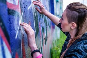 Girl drawing on wall