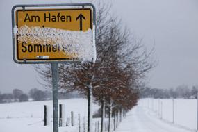 yellow lettering in the snow in the field