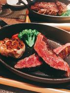 meat and vegetables on a wooden plate