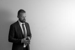 pensive man with a beard in a business suit