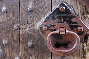 antique metal handle on a wooden gate