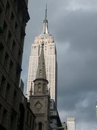 a big white building with clouds