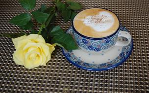 yellow rose near the coffee