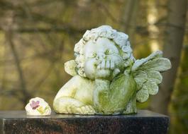 a cute sculpture of a green angel