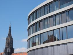 cathedral is reflected in a modern glass facade