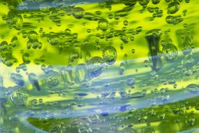 Abstract, bright green liquid background with bubbles
