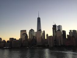 skyscrapers of new york near the water at dusk