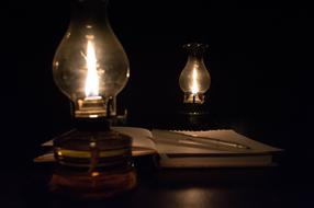 a lamp with books in the dark