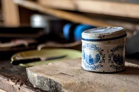 an iron can on a wooden table