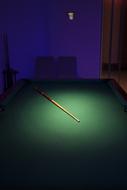 a stick on a pool table landscape.