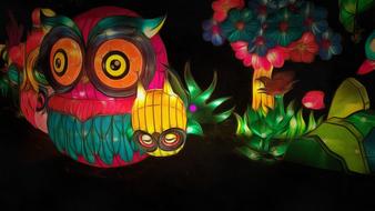 Colorful and beautiful decorations with owl, in floodlit, among the darkness