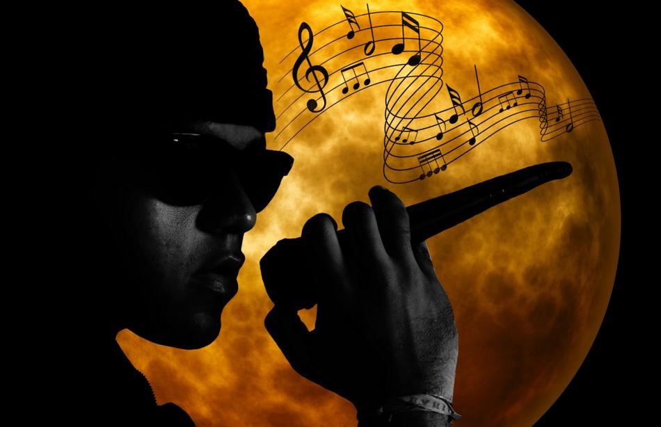 face of young boy with microphone at full moon, singer