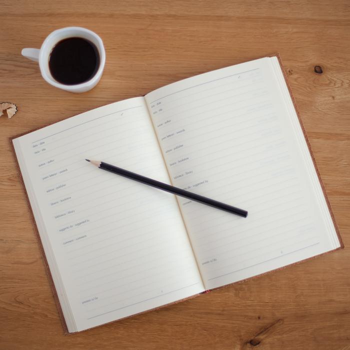 open notebook and a cup of coffee