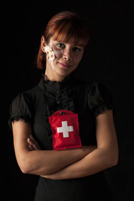 girl with a red medical cross on her clothes