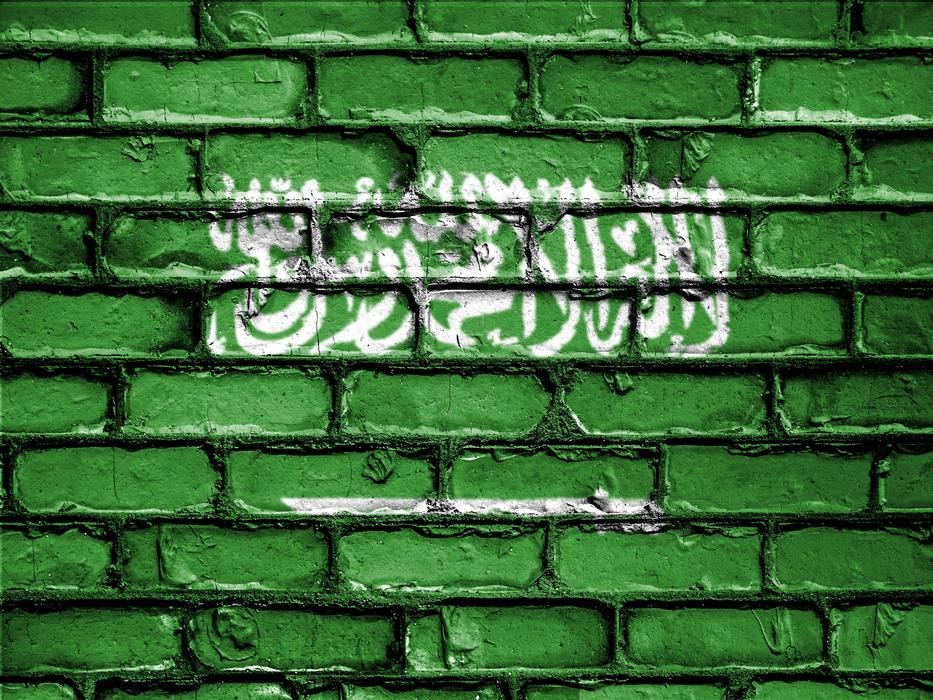 green stone wall with an inscription