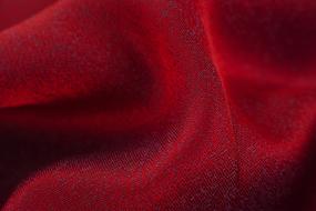 Close-up of the beautiful, red fabric texture, with the shadows