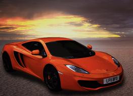 orange ferrari car against the sunset