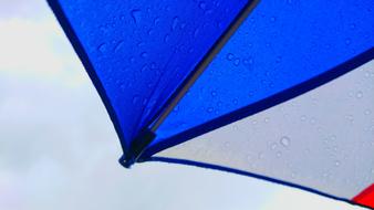 a colored umbrella in water droplets