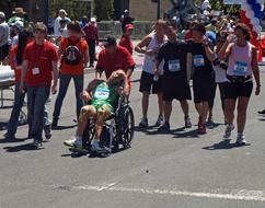 people in a stroller sporting a walker