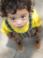 photo of a little boy in a yellow t-shirt