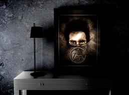 male portrait in frame on table at wall