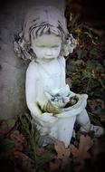 statue of a seated girl in the cemetery