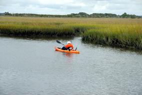 elderly man in Kayak on calm water at summer