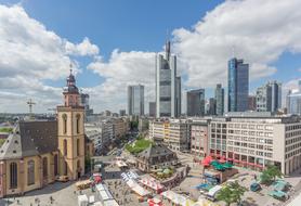 Beautiful aged, brown St Catherine's church and modern glass skyscrapers in city, Germany, Frankfurt