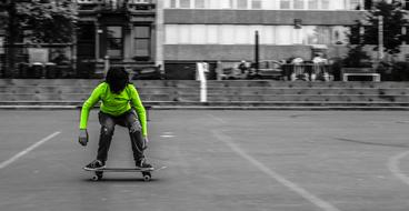 Boy standing on Skate in city